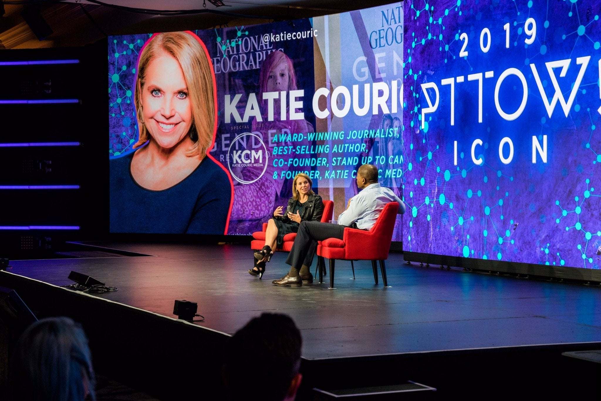 Katie Couric speaking on stage at 2019 PTTOW ICON event with LACE leads the Glam Squad branding on screen