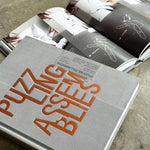 Puzzling Assemblies book cover by Dwayne Oyler and Jenny Wu with architectural puzzle design elements