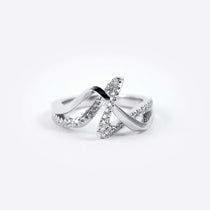 Amare Diamond Ring featuring a unique loose knot design with intertwined diamond-pave and polished metal lines