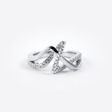 Silver engagement ring sample with crisscross design and embedded stones