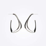 Sterling silver Amare Aura Set earrings with twisted loop design on white background