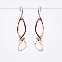 Centri Earrings in 18K rose gold vermeil with long loose knot design and elegant precision edge detailing
