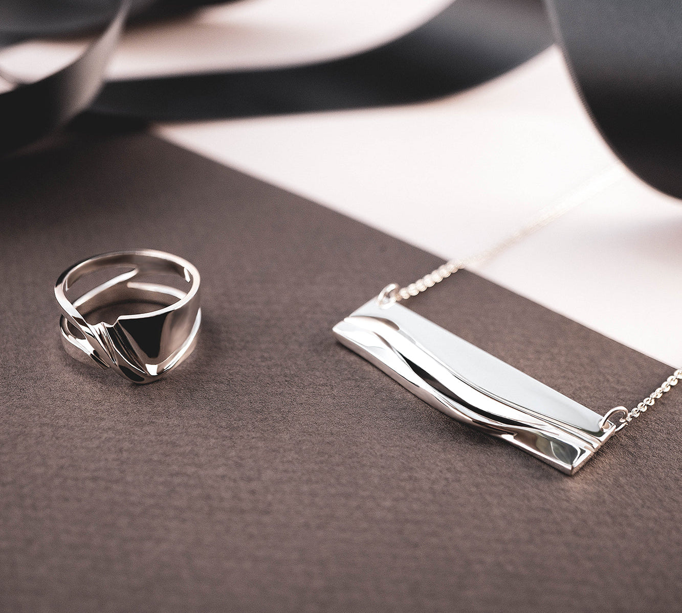 Adagio Velum Set sterling silver ring and pendant with rippling curves and precision edges