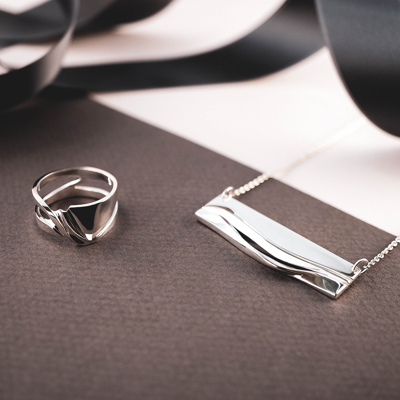 Adagio Velum Set sterling silver ring and pendant with rippling curves and precision edges