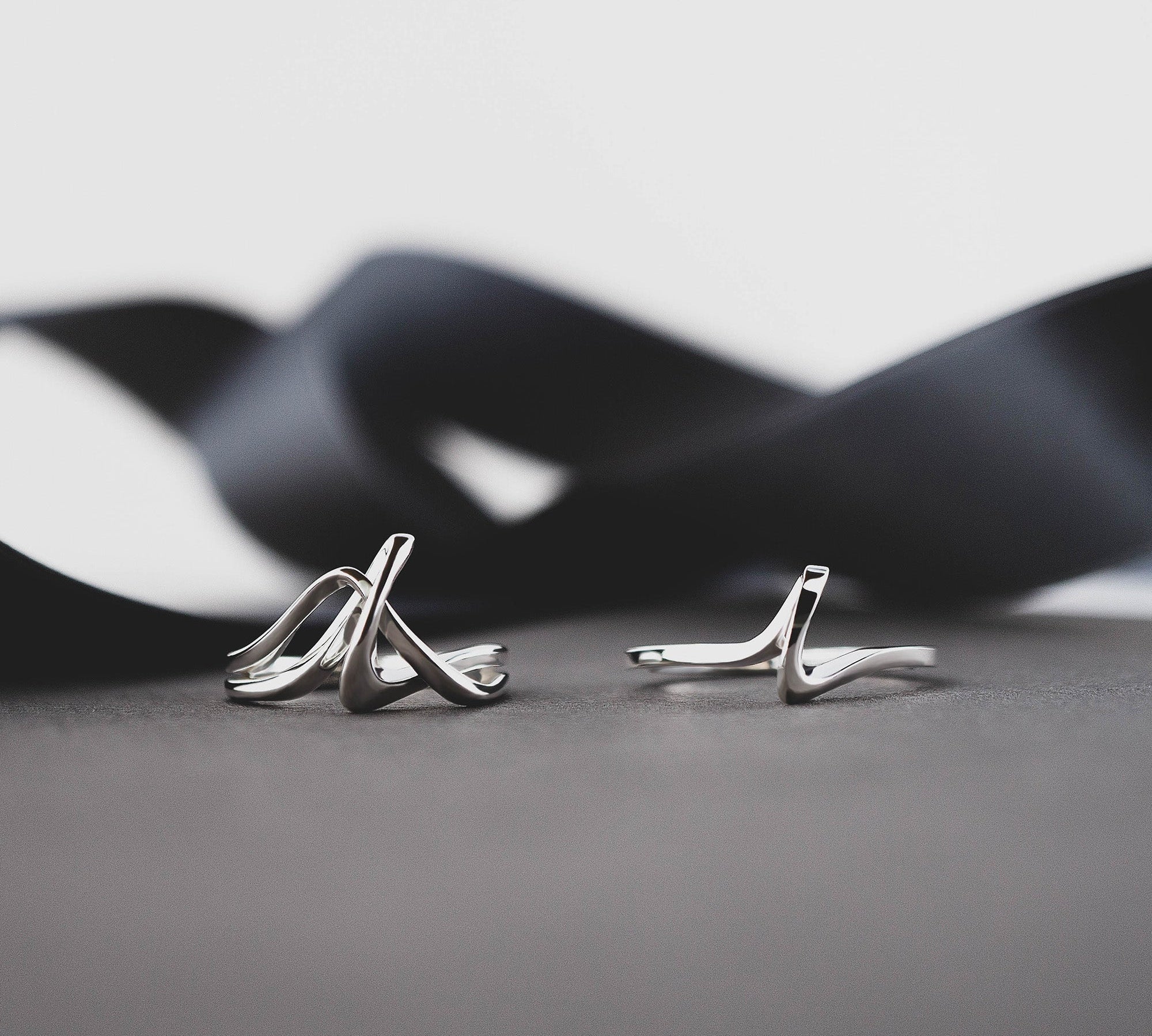 Amare Sera Ring set of two sterling silver rings with knot design on gray surface