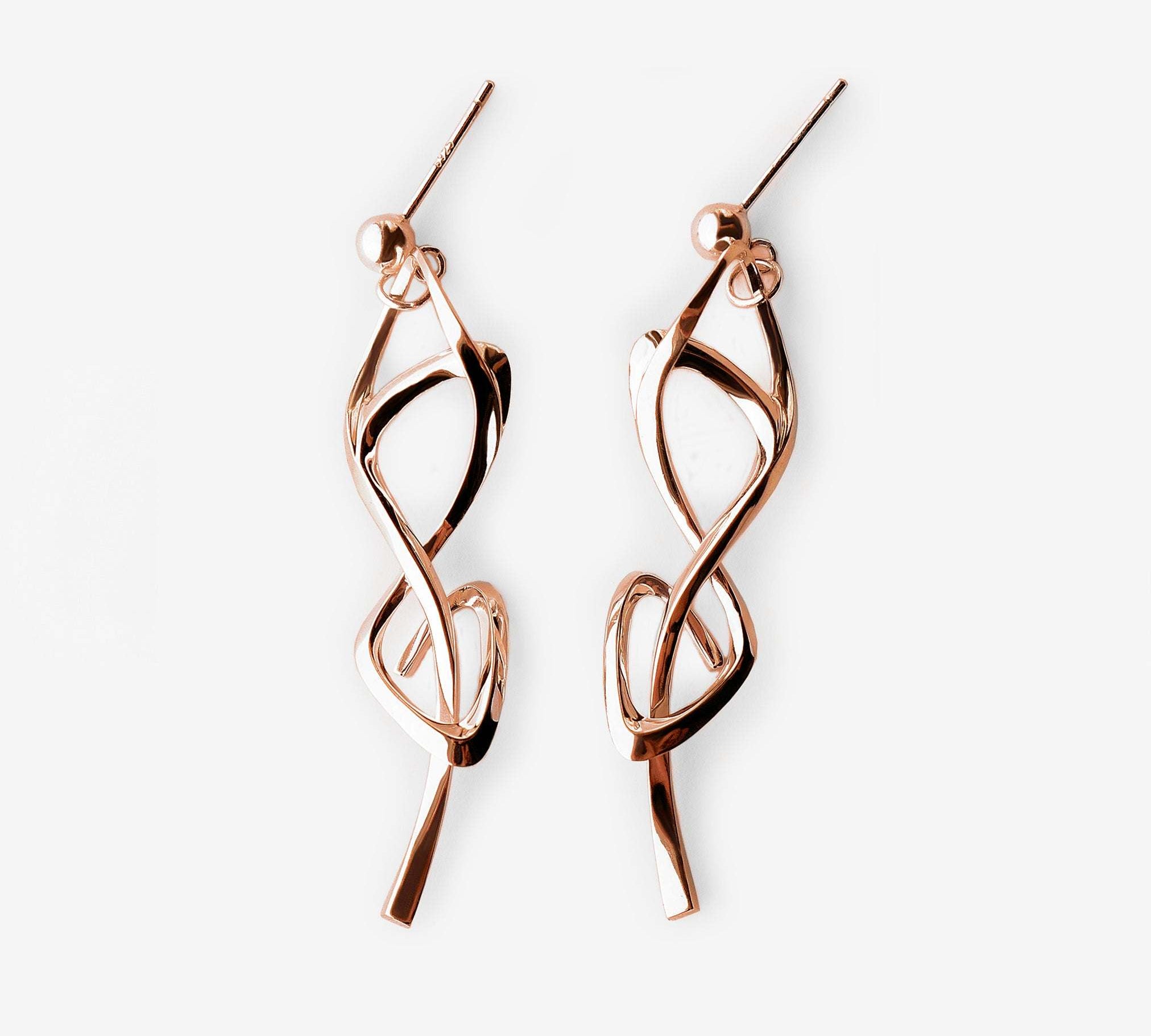 Rose gold Nova earrings with elegant undulating knot design and high-precision edges.