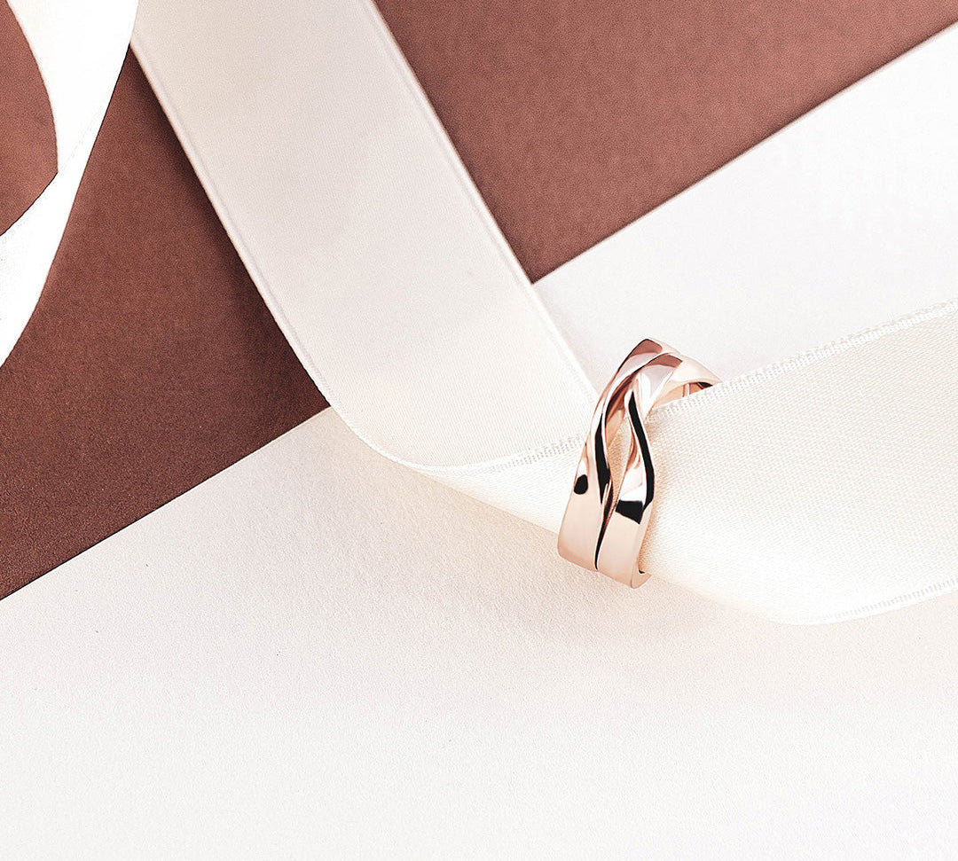 Amor Amos Light Set rose gold stackable twisting rings on white ribbon