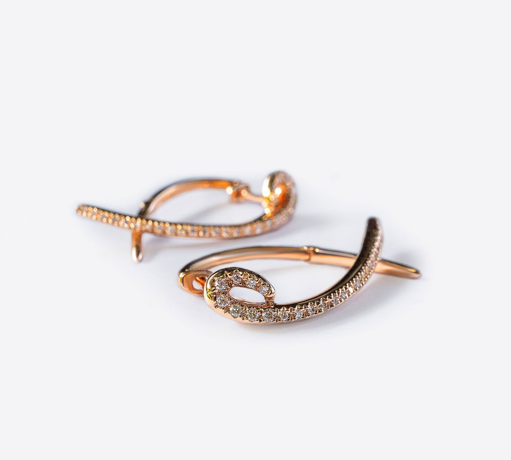 Hydra diamond earrings in 14K rose gold with 0.11 carats sparkling diamonds and elegant looped modern huggie design