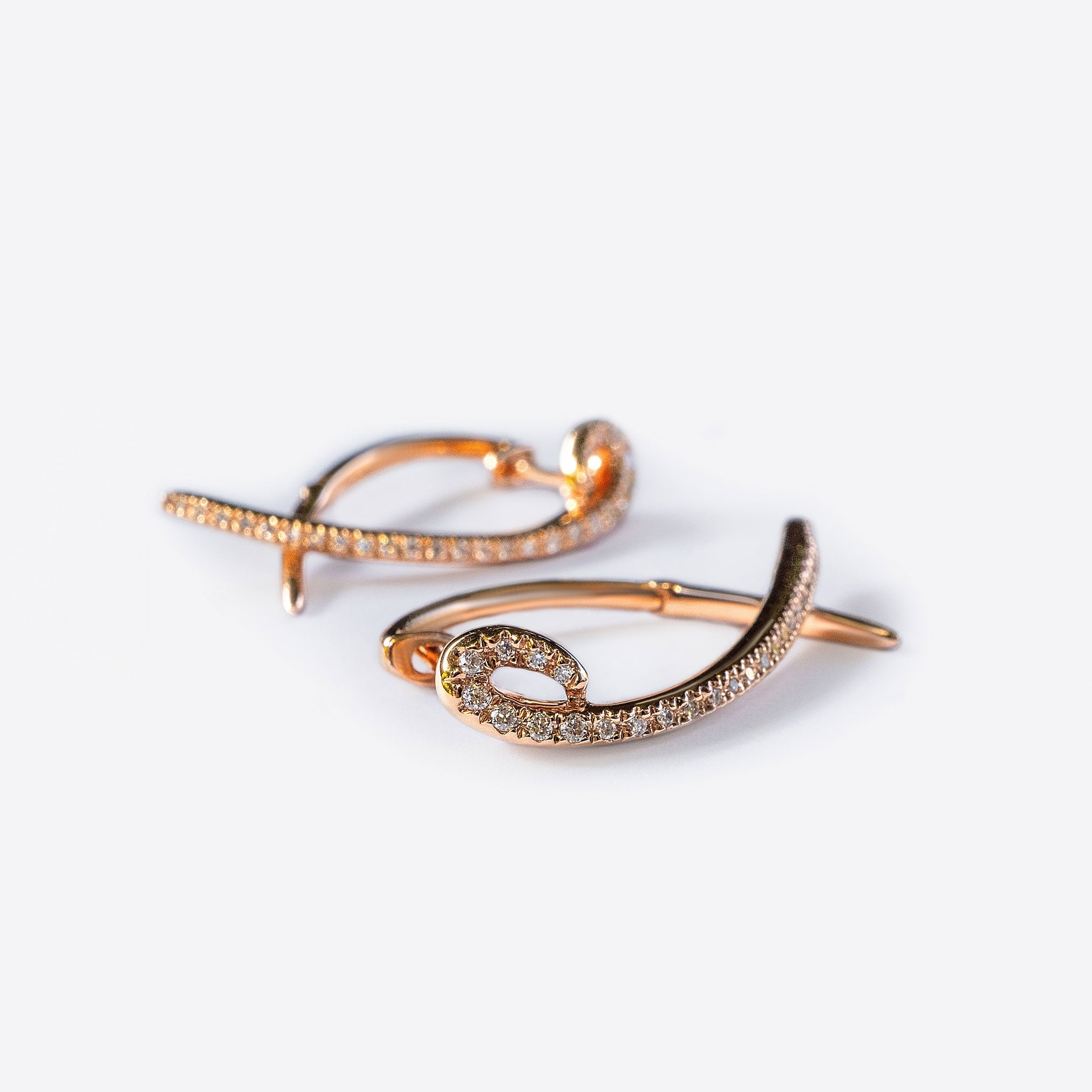Hydra diamond earrings in 14K rose gold with 0.11 carats sparkling diamonds and elegant looped modern huggie design