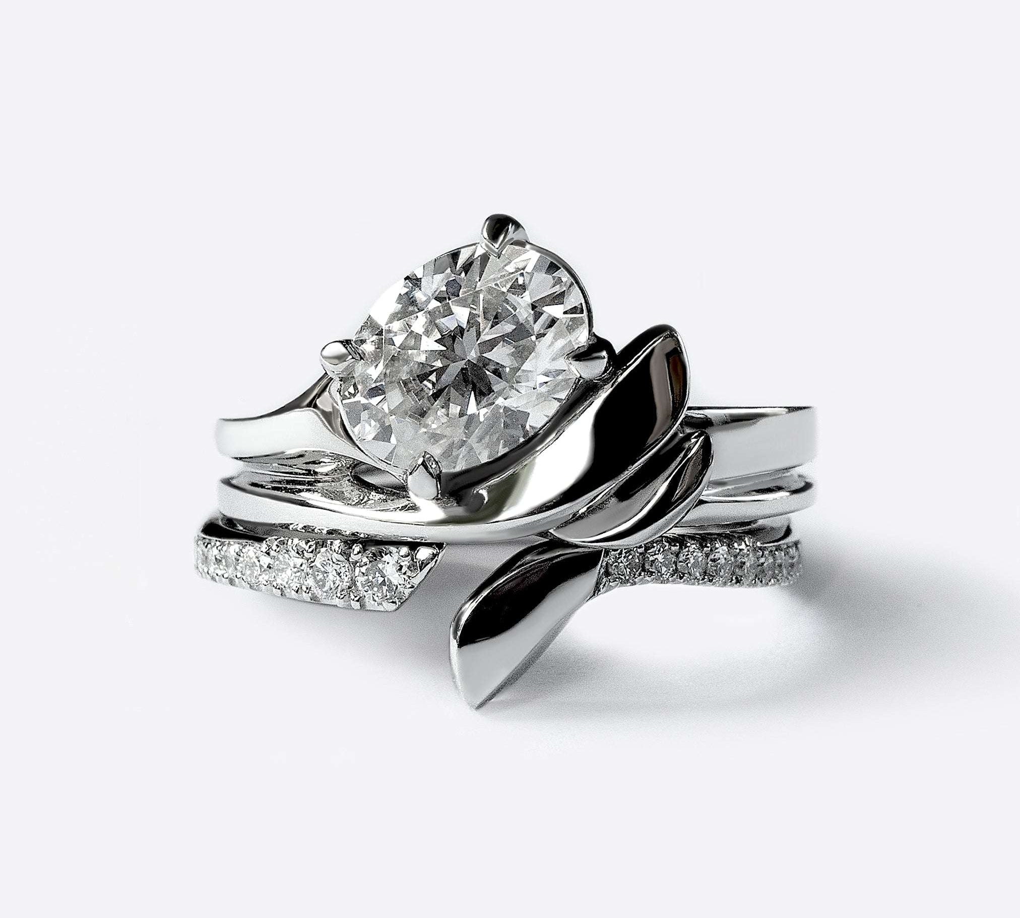 Close-up of Rosae Wedding Band in platinum with diamond, featuring sculpted petal design and pavé diamonds.