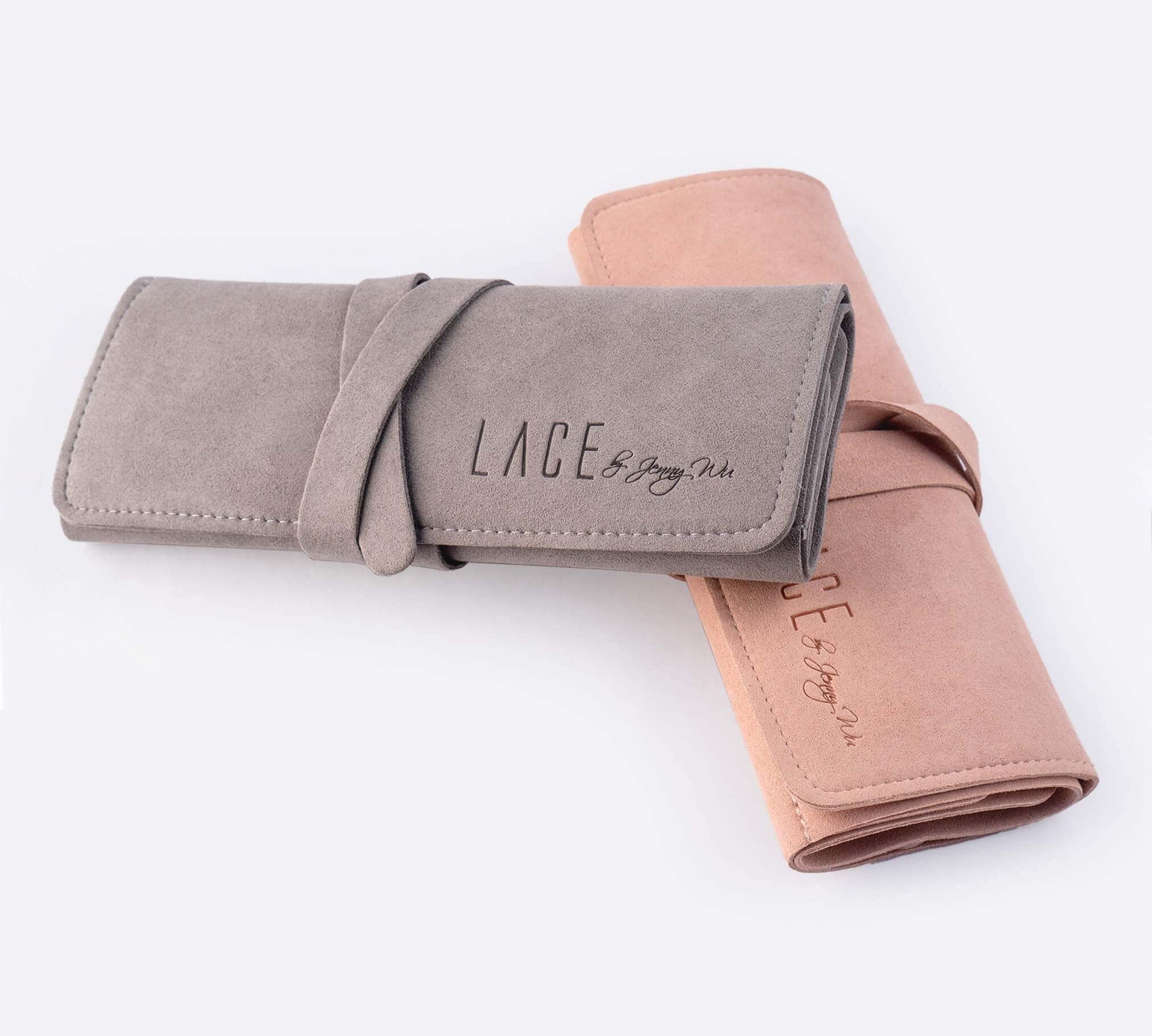 Travel jewelry roll organizer in gray and pink microfiber for rings, earrings, necklaces, and bracelets.