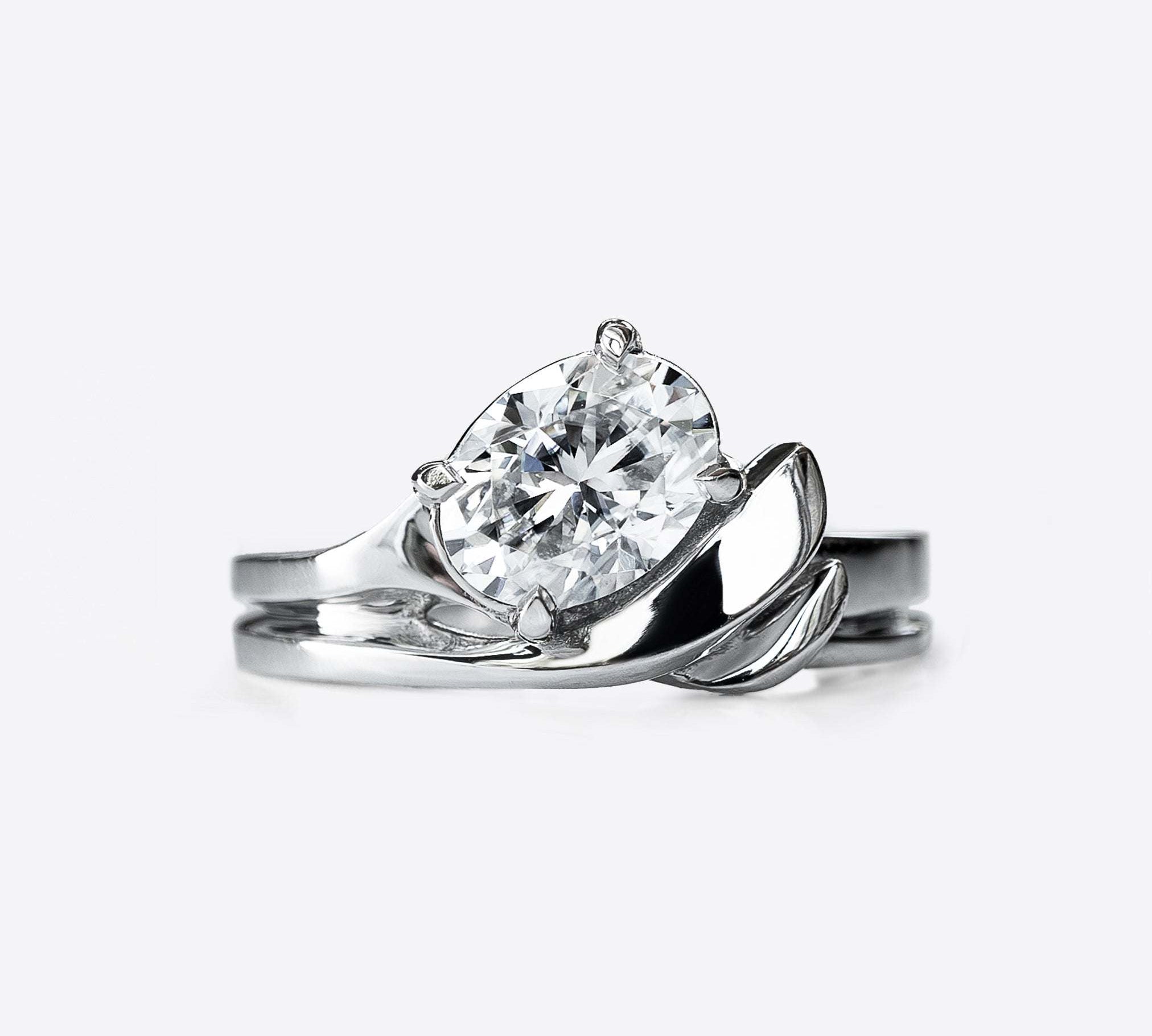 Calyx Diamond Ring with 1.3 carat oval solitaire and intertwined band design