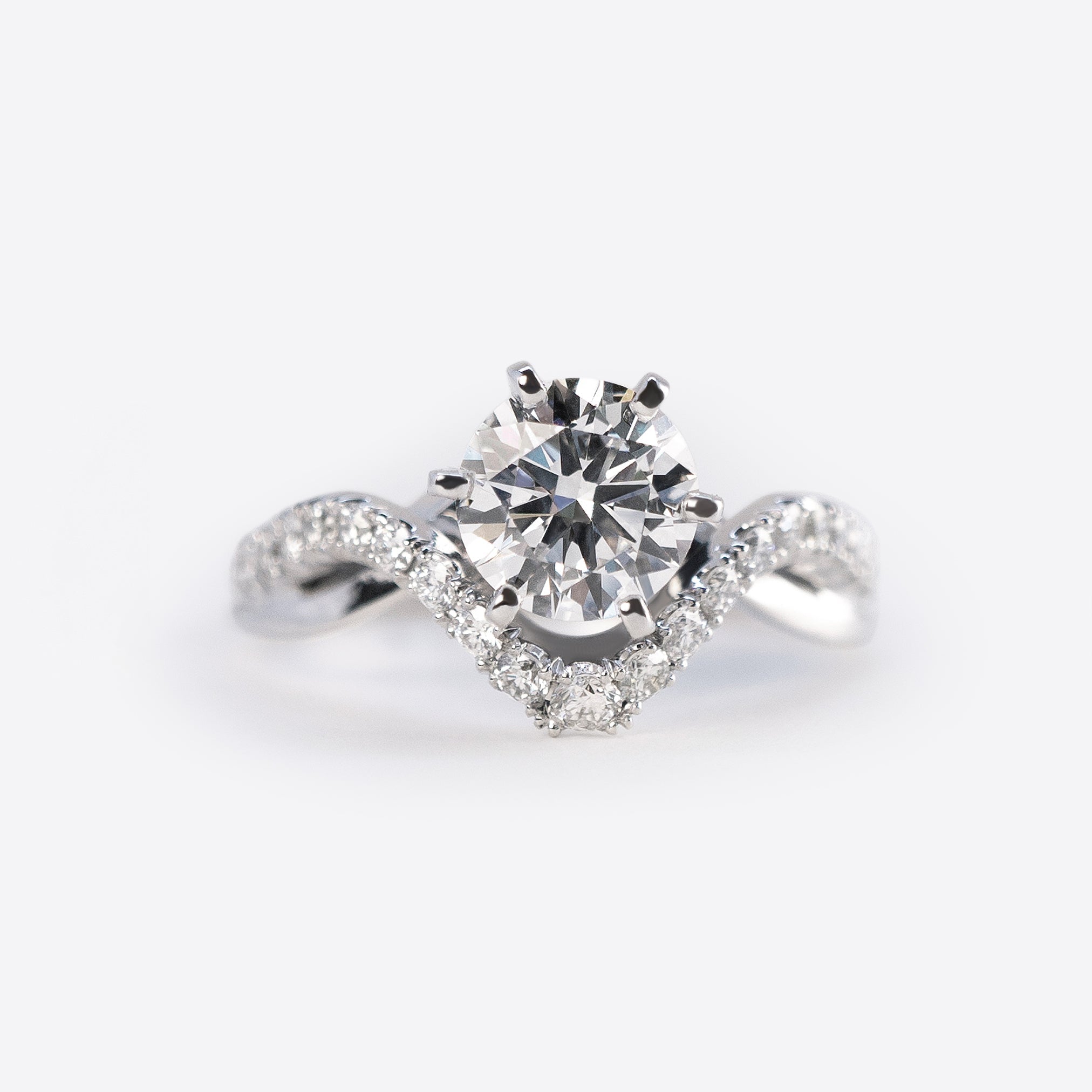 Close-up of a diamond engagement ring sample from the Engagement Ring Samples Set with a twisted band studded with small diamonds