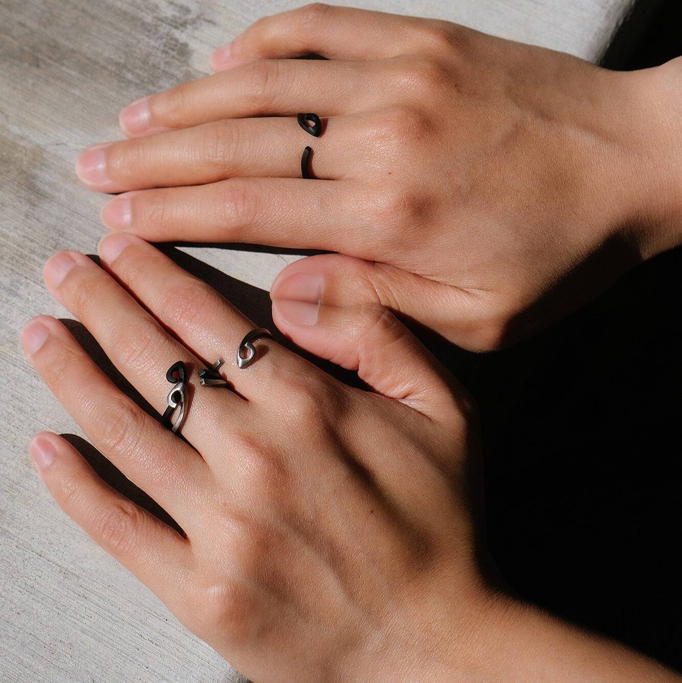 Hydra Stainless Steel Ring on fingers with open curved design and black finish