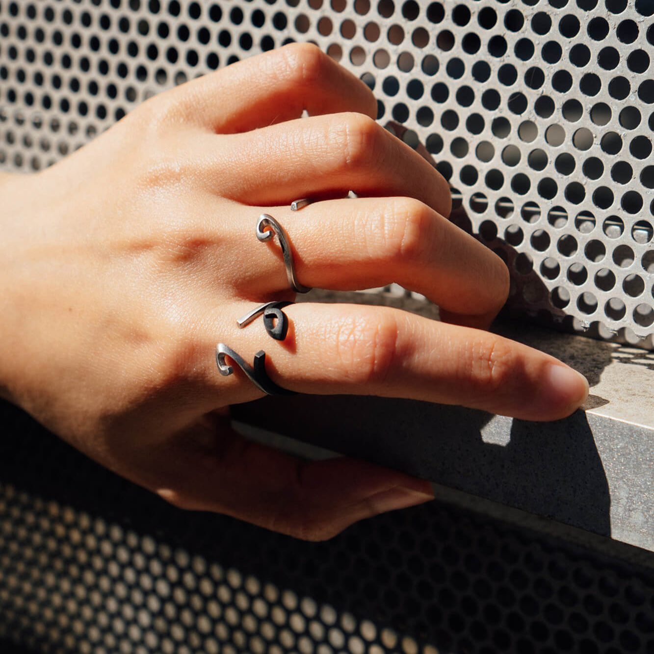 Hydra Stainless Steel Ring with open single curve design worn on hand, modern and sleek jewelry accessory