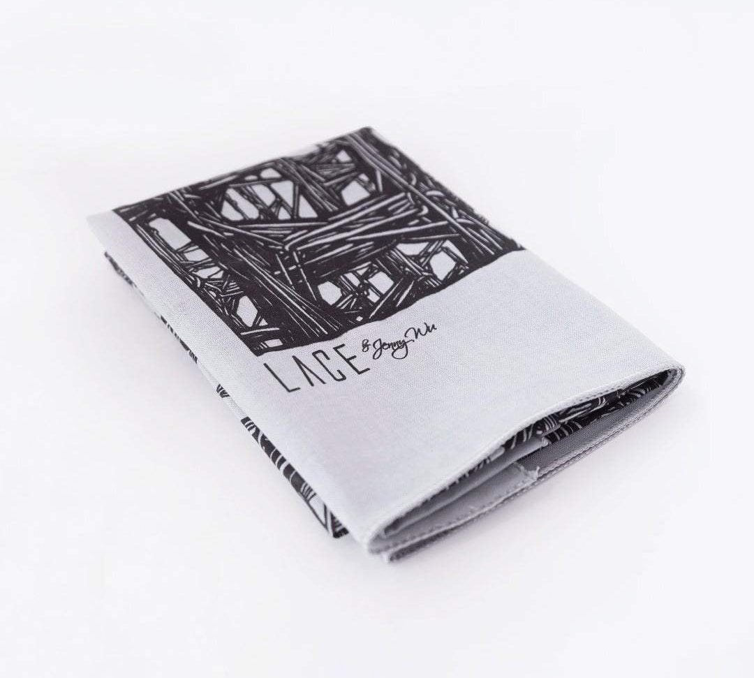 Folded Lineworks Bandana with black signature hand drawing on white premium cotton