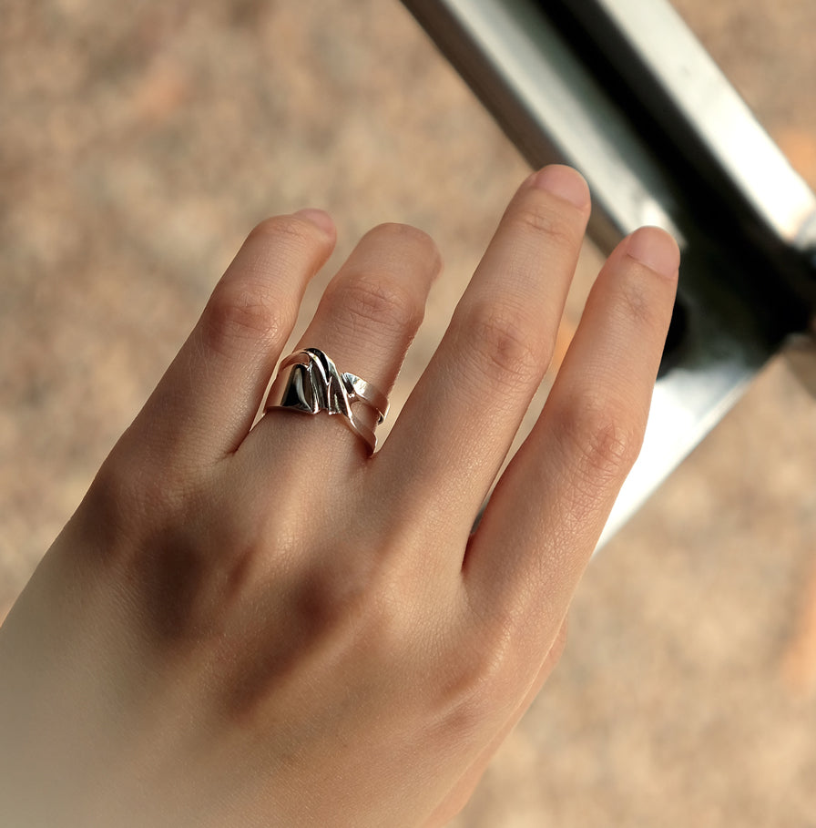 Sterling silver Adagio Velum Set ring with rippling curves on hand