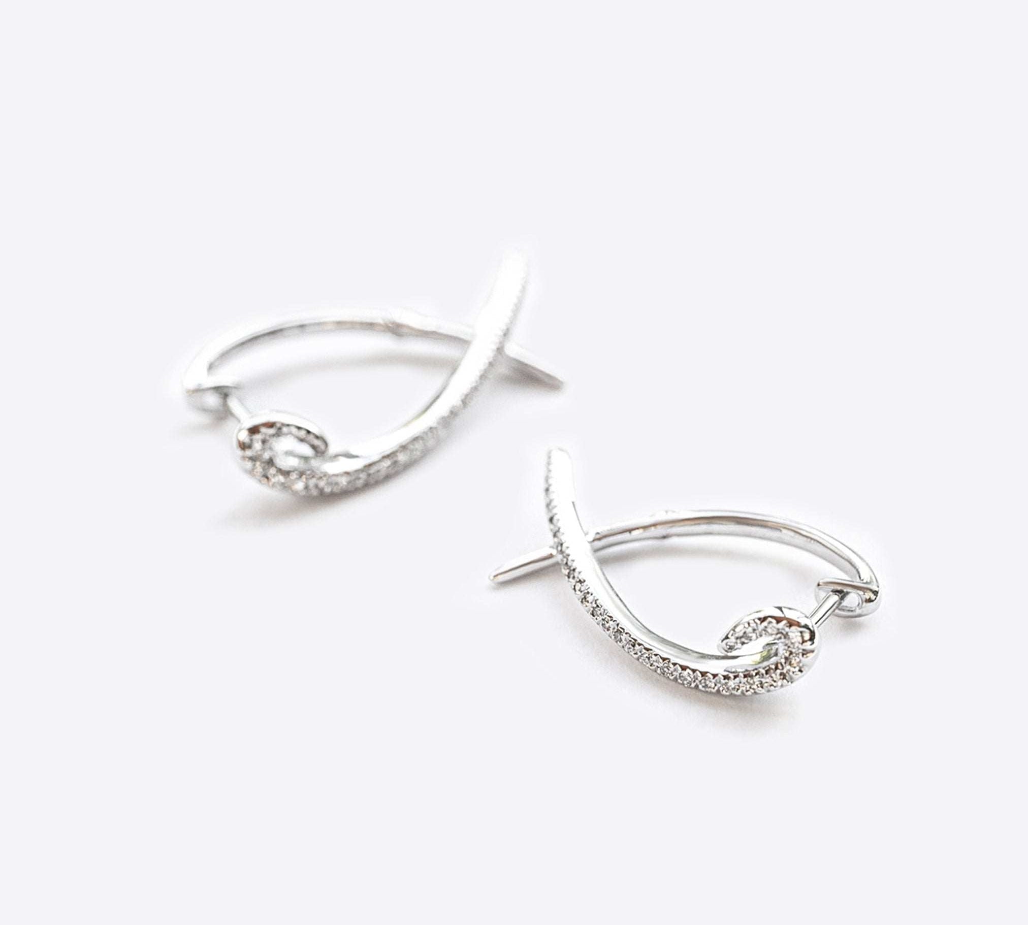 Hydra diamond earrings in 14K white gold with 0.11 carats round brilliant diamonds and modern looped huggie design