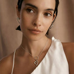 Minimalist heart charm necklace in sterling silver with delicate geometric design