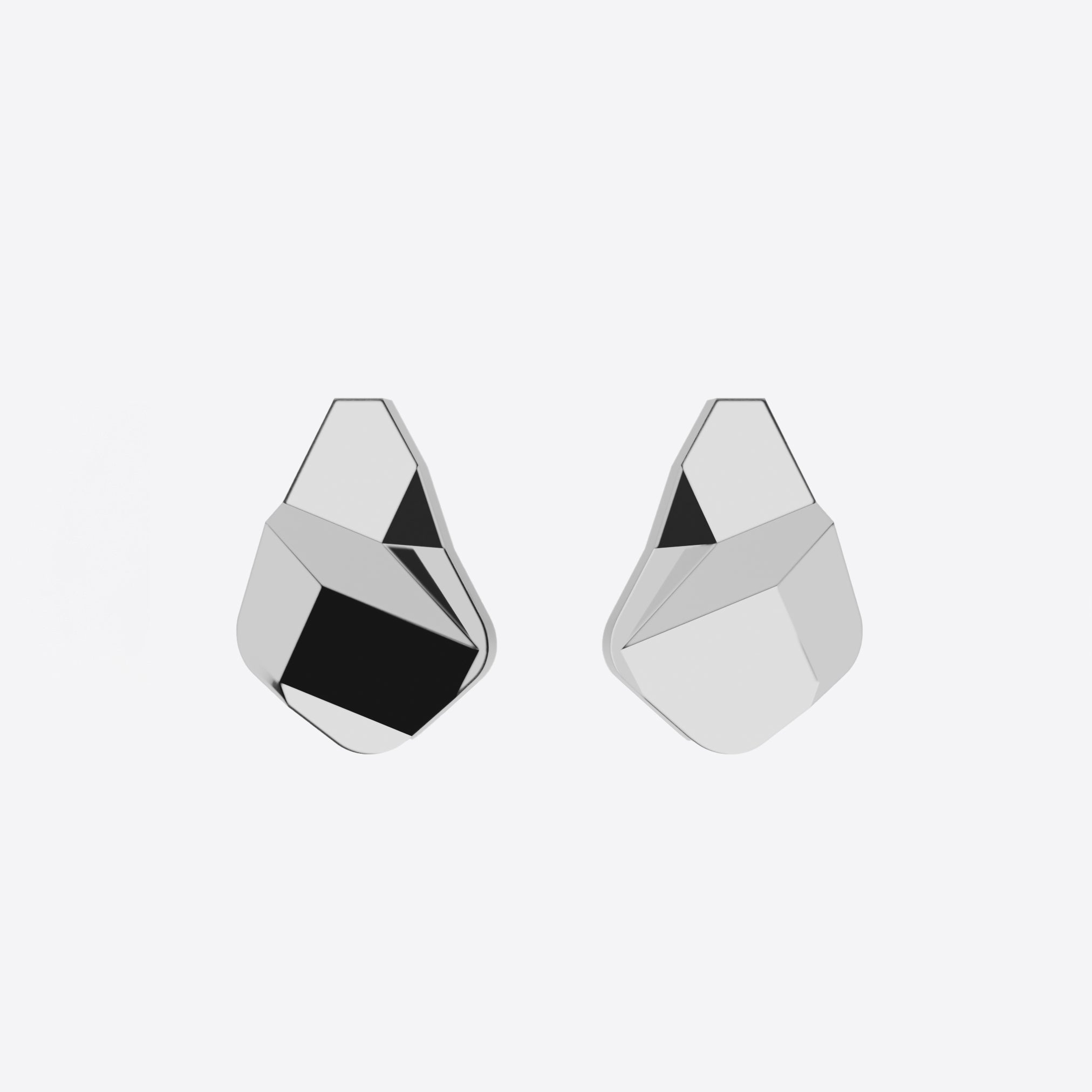 Sterling silver Prism earrings with faceted angular surfaces and a sculptural geometric design.