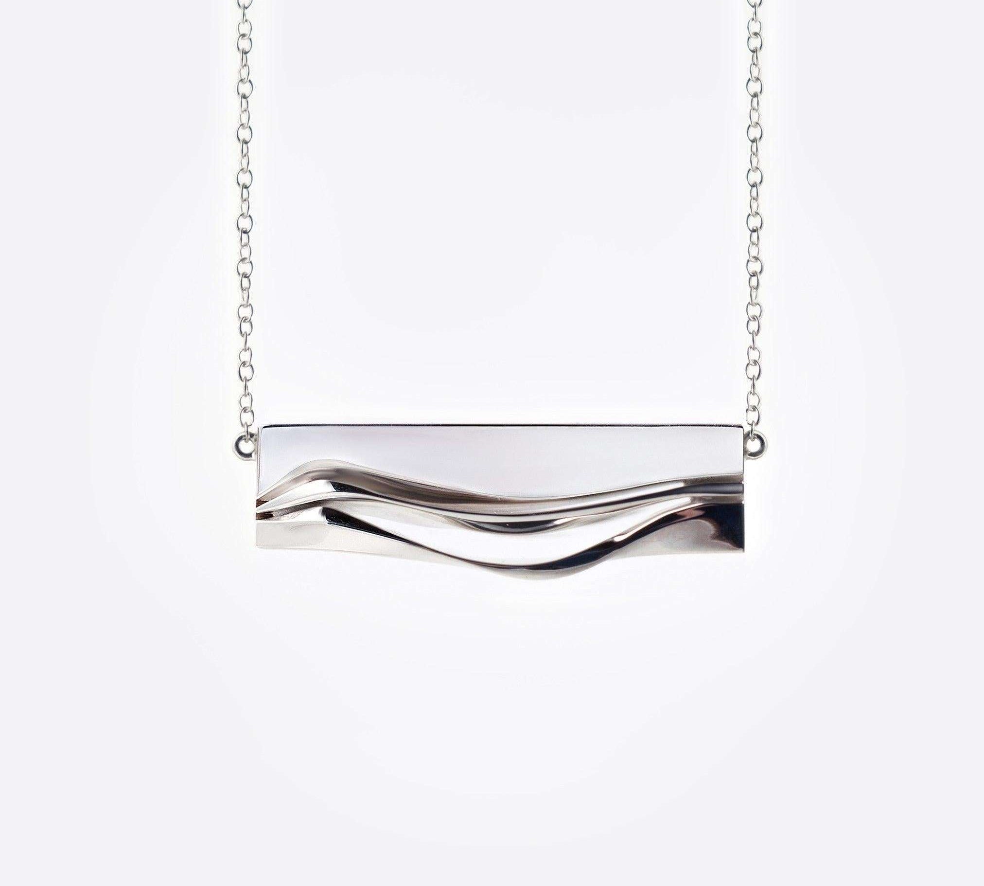 Sterling silver Adagio Pendant with twisting, stacking curves and mirror finish on a delicate chain