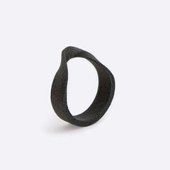 Gray nylon Amos Sample Ring with twisting band and precision edge detailing against white background