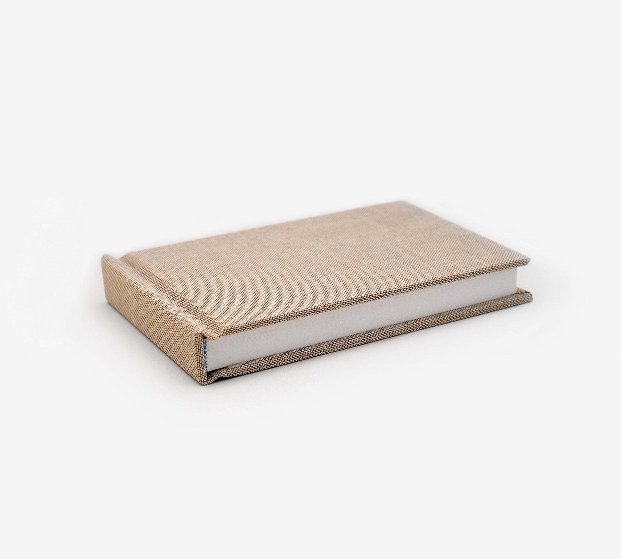 Natural linen cover sketchbook with heavyweight smooth white paper and sewn binding, 88 pages, designed to lay flat.