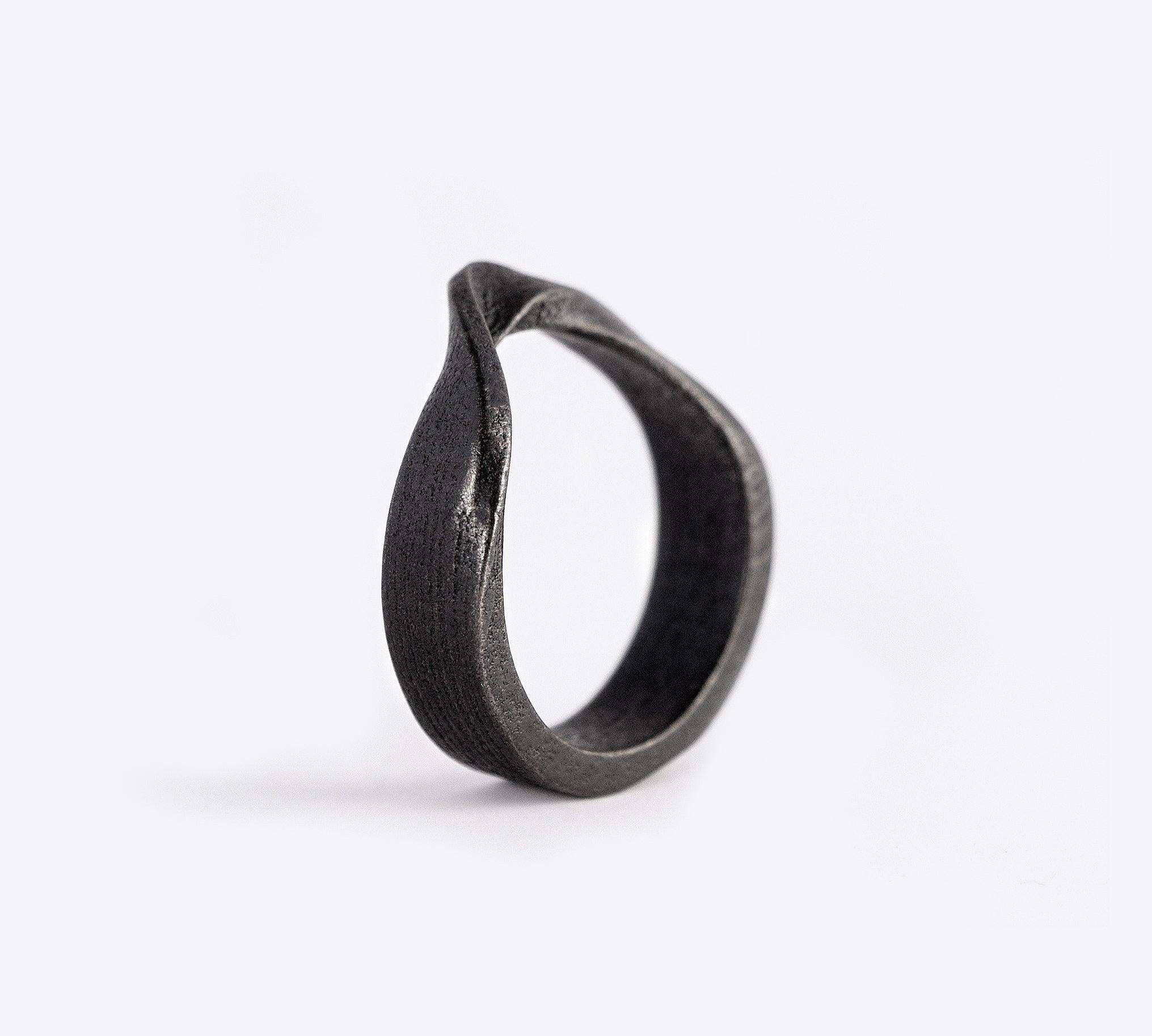 Amos Bold Steel Ring in gray with twisted band and precision edge detailing on white background