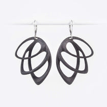 Orbis Steel Earrings in black with three elliptical petals and custom felt pouch